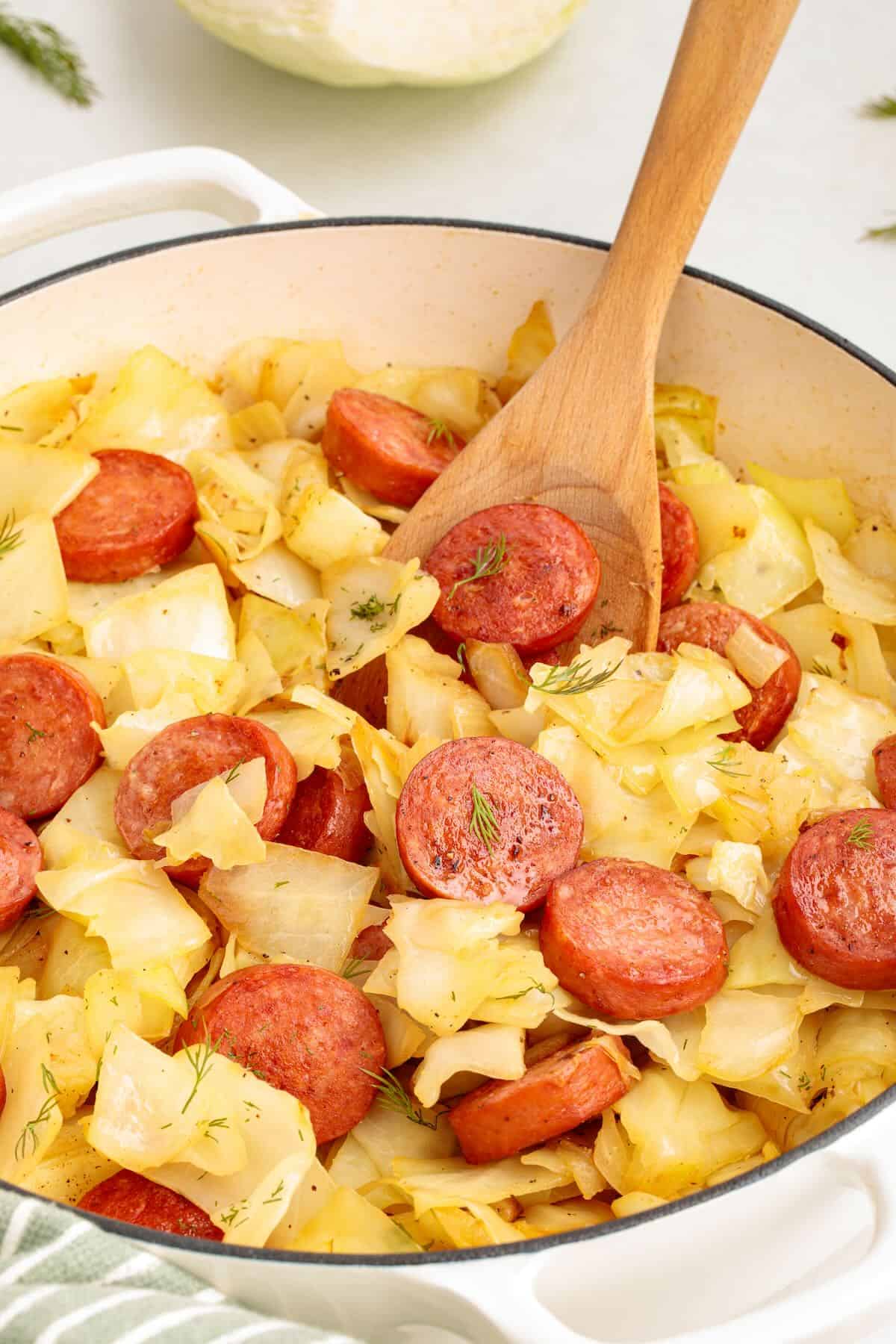 Kielbasa and cabbage skillet with onions and fresh herbs.
