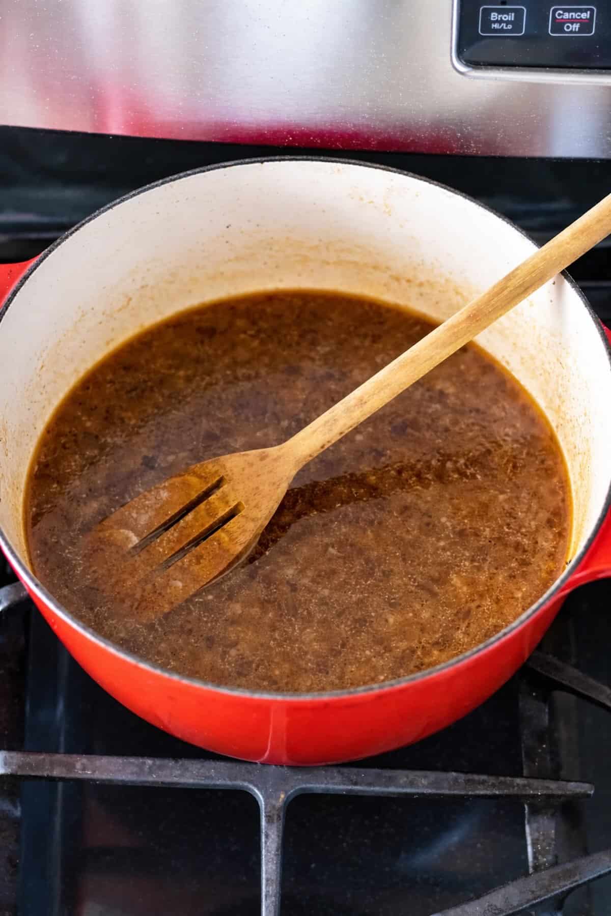 A wooden spoon for scraping brown bits from the Dutch oven with beef broth and seasonings added.