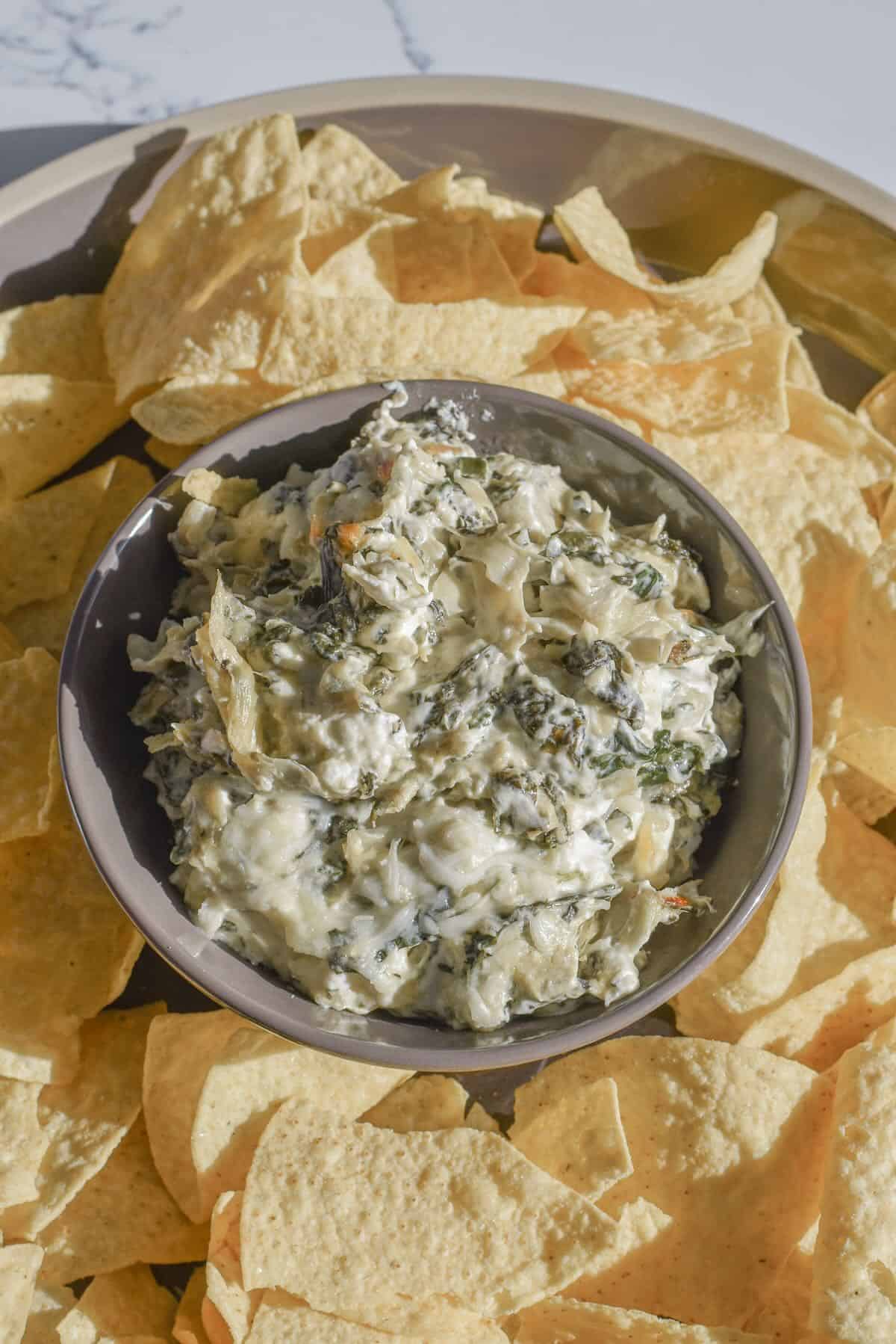 Creamy spinach artichoke dip with fresh spinach and melted cheese.