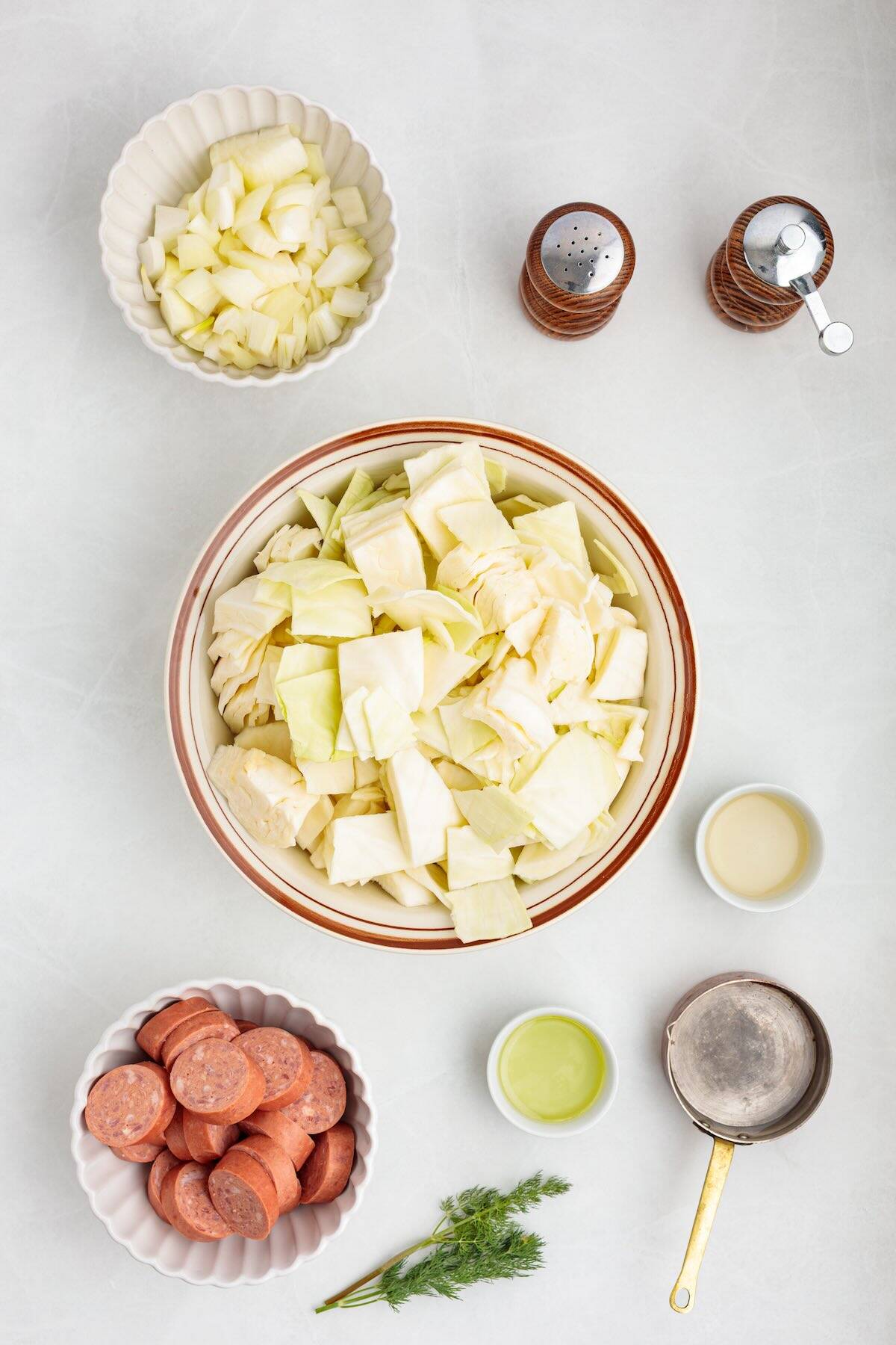 Ingredients to make a cabbage and kielbasa meal in one pan.
