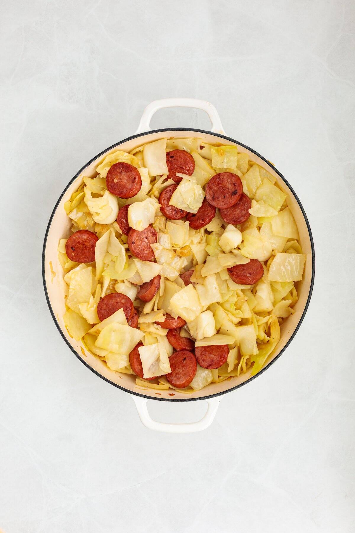Kielbasa and cabbage simmering in one pan.