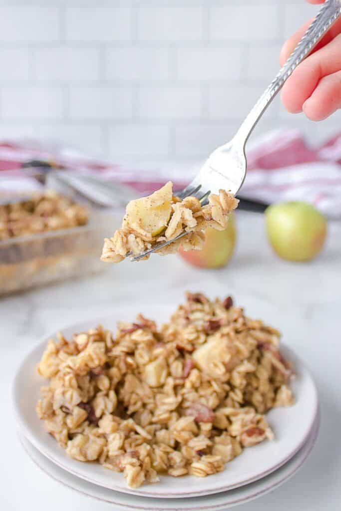 Slicing apple baked oatmeal for serving.