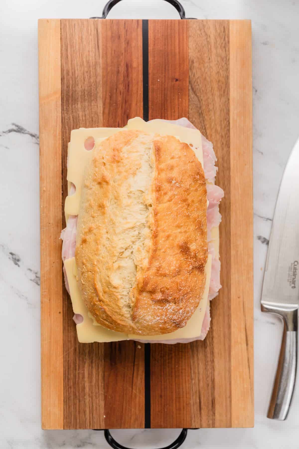 Crusty bread buttered and ready to heat to make a cuban panini.