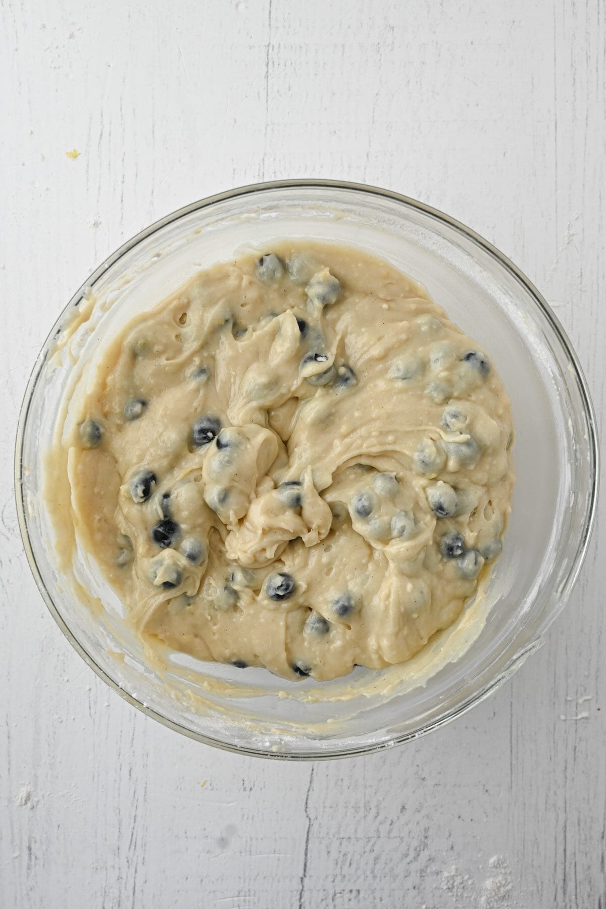Blueberry muffin batter mixed in a bowl before baking.