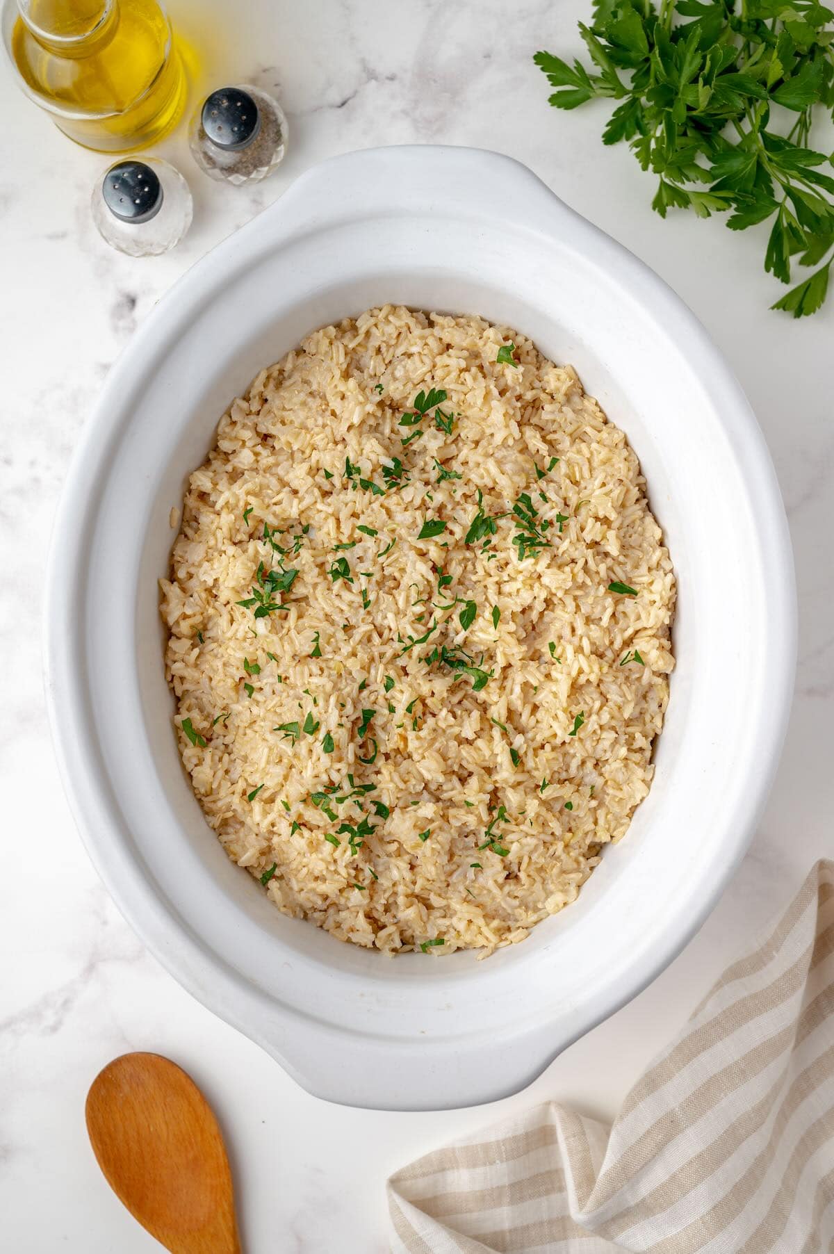 Brown rice cooking in crockpot insert.