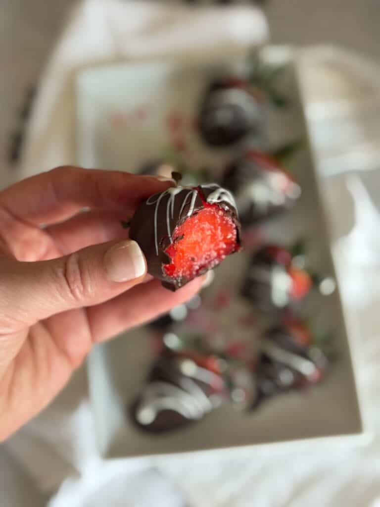 Inside of a chocolate covered strawberry showing fresh juicy strawberry center.