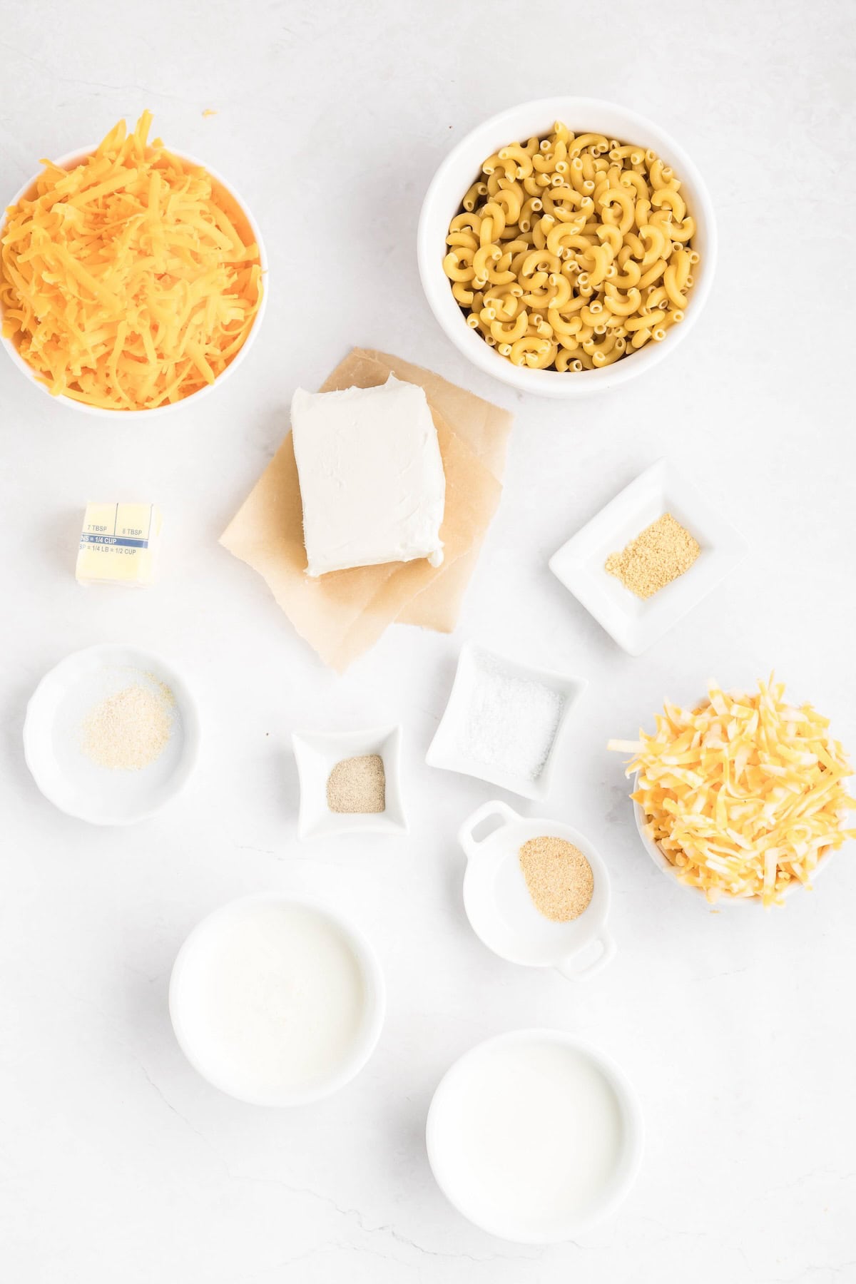 Shredded cheddar and Monterey Jack with macaroni, milk, cream and cream cheese for homemade stovetop mac and cheese.