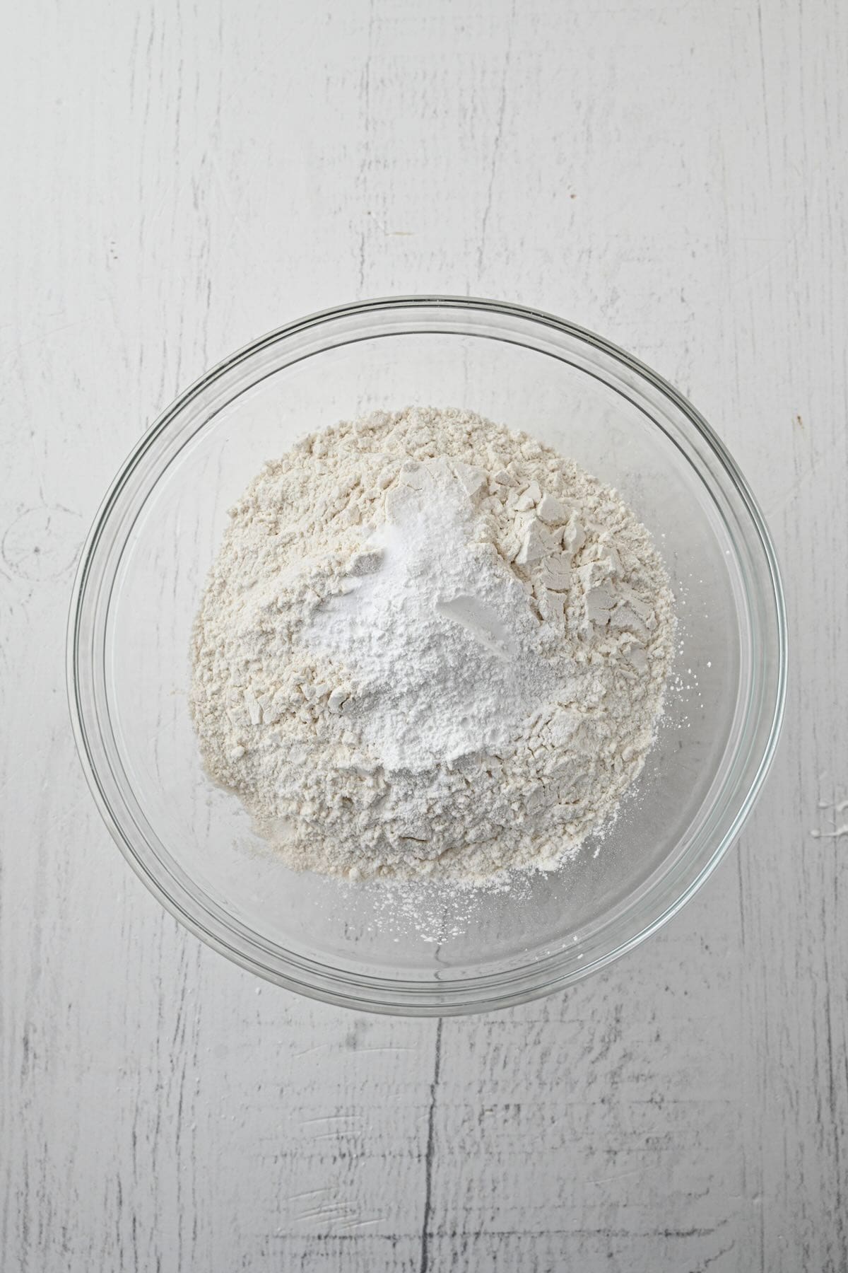 Flour, sugar, baking powder and baking soda in a mixing bowl.