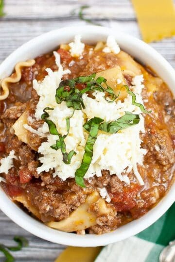 A bowl of hearty lasagna soup topped with three cheeses, fresh from the Instant Pot.