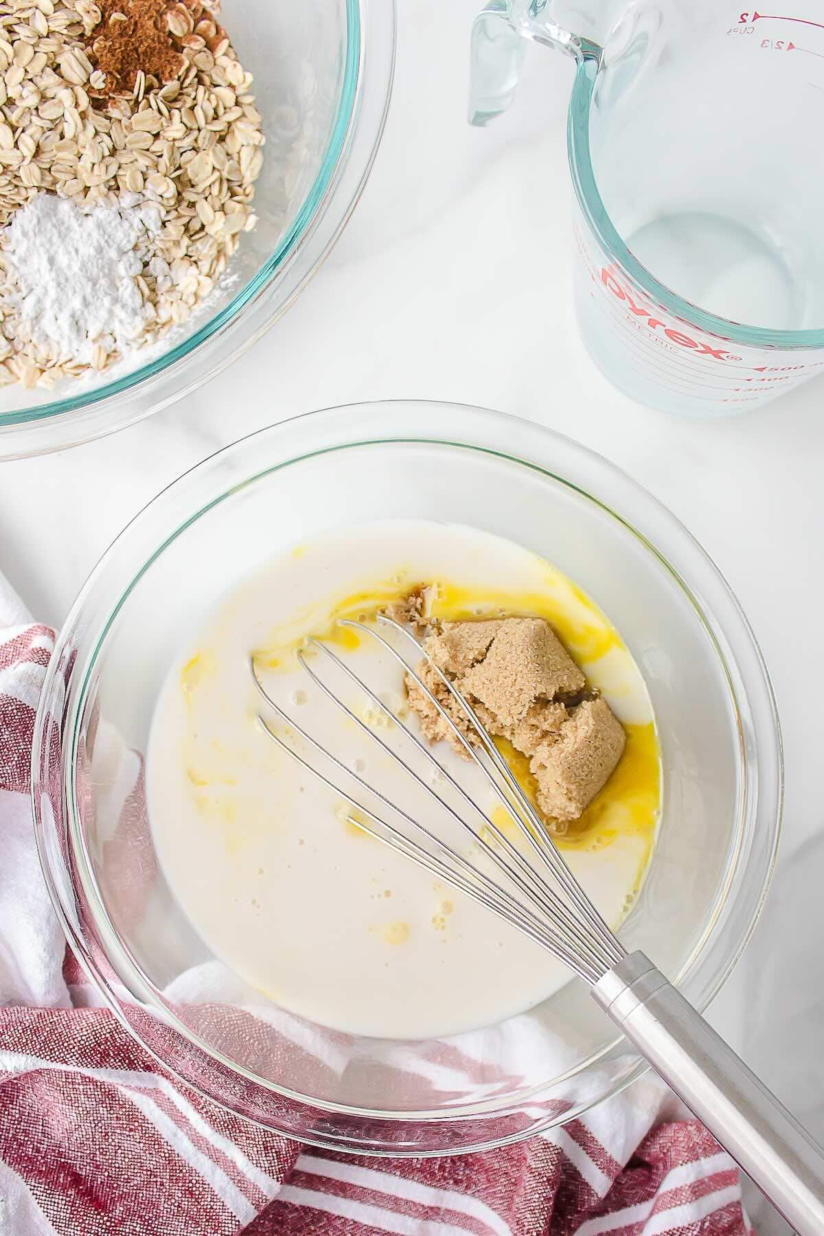 Mixing eggs, milk, and sugar for apple baked oatmeal.