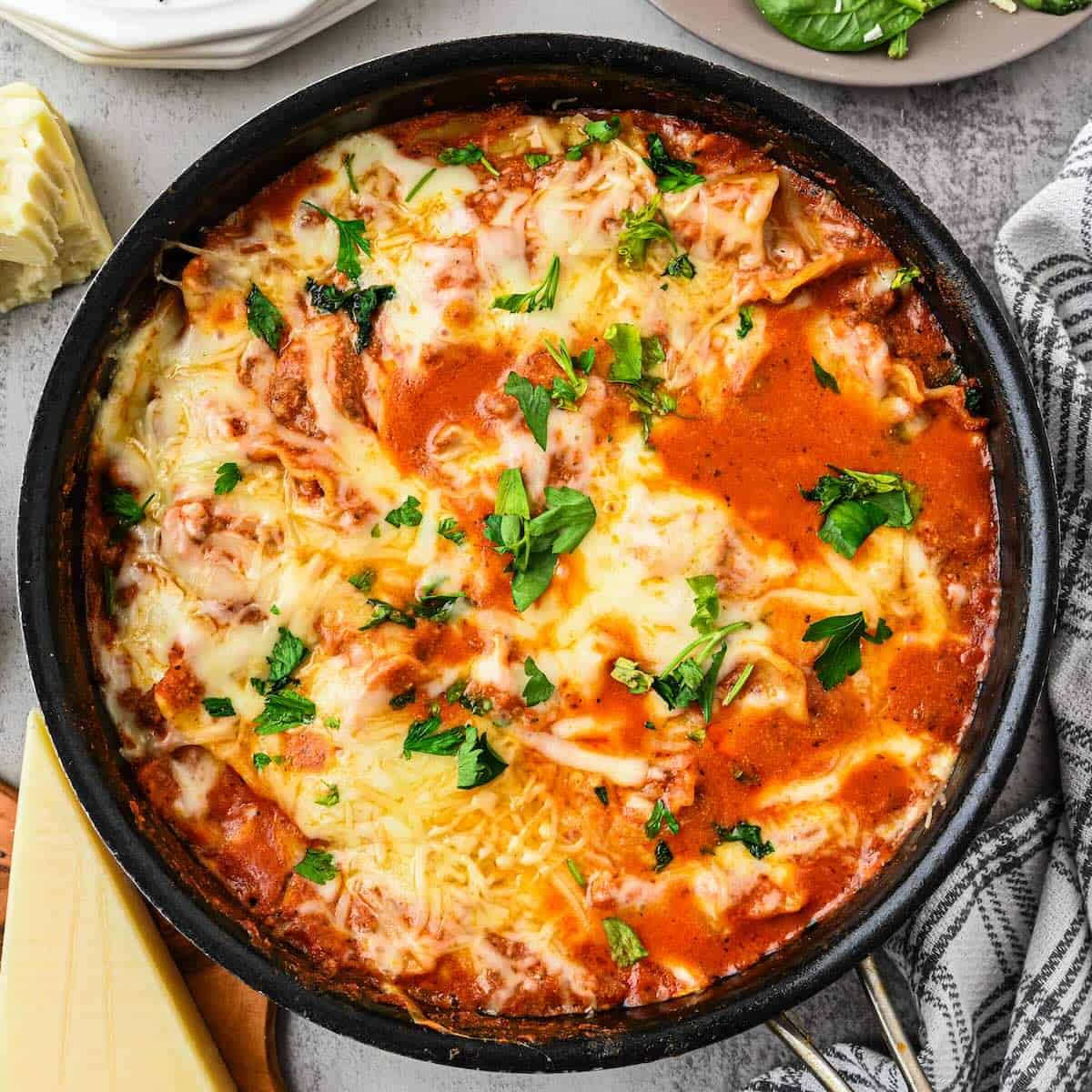 Saucy noodles, melty cheese, browned ground beef and lasagna noodles cooked in a skillet.
