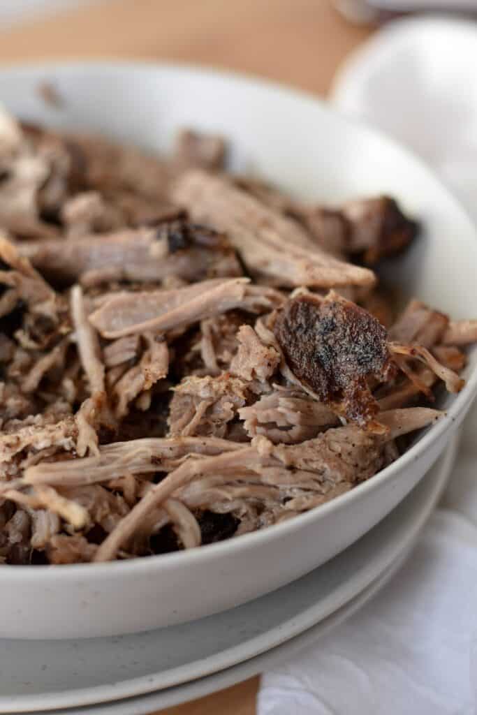 Tender air fryer pulled pork in a bowl, ready for serving.