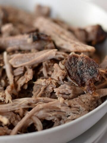 Juicy shredded air fryer pulled pork in a bowl ready for topping with bbq sauce.