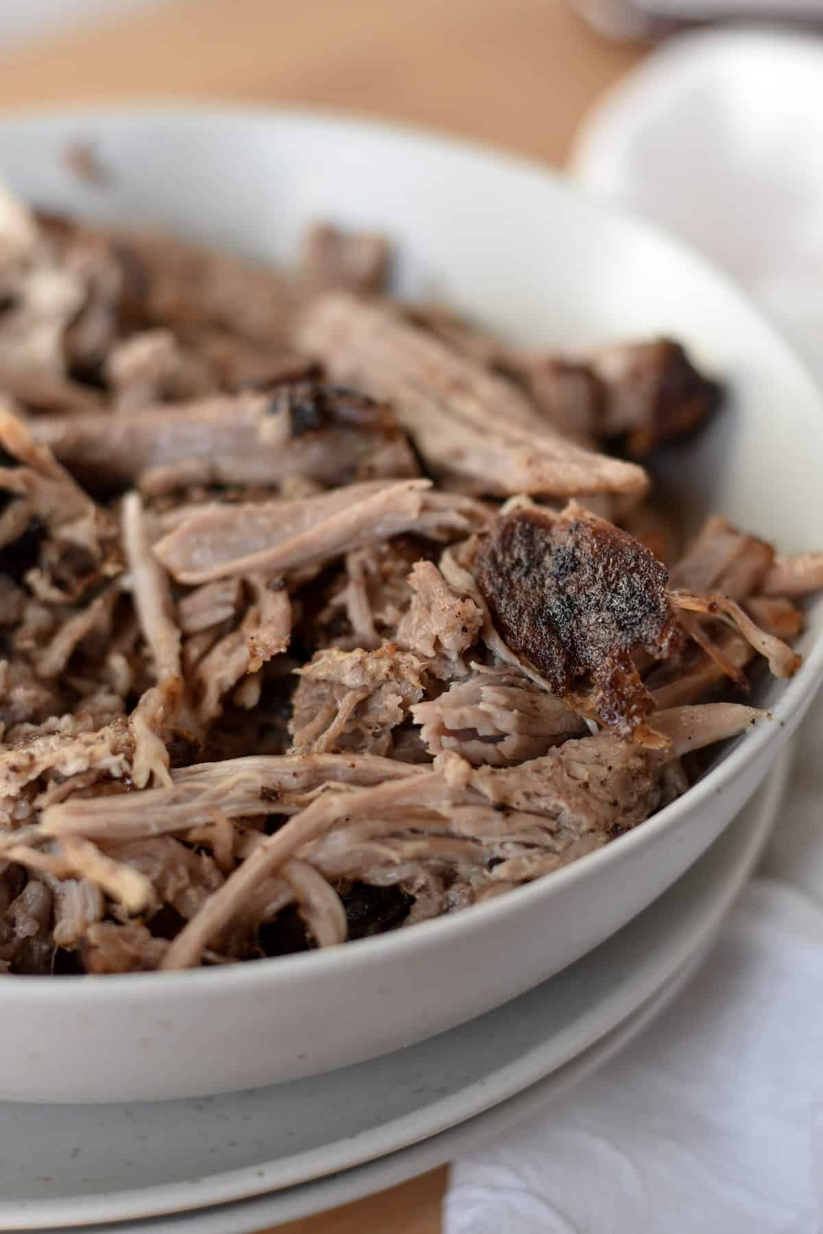 Tender air fryer pulled pork in a bowl, ready for serving. 