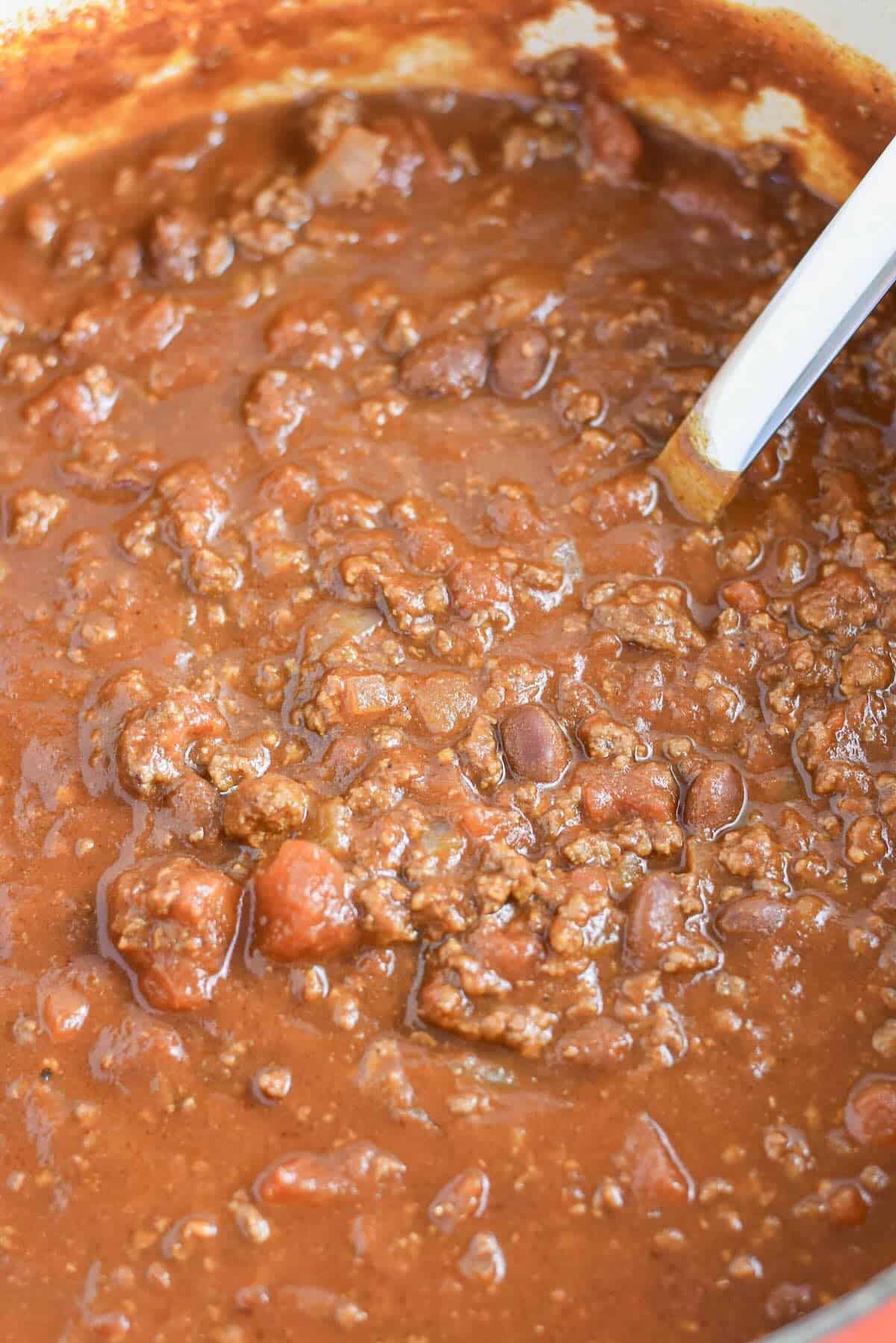 Classic chili for a crowd simmering in a Dutch oven.