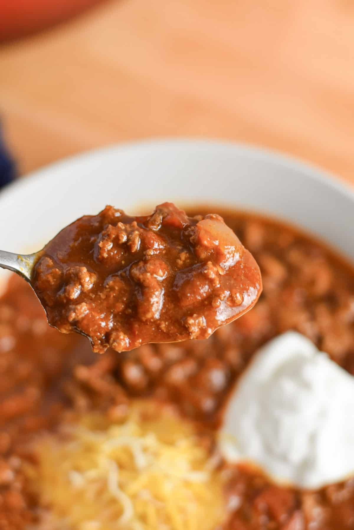 Close-up of thick classic chili made for a crowd on a spoon.
