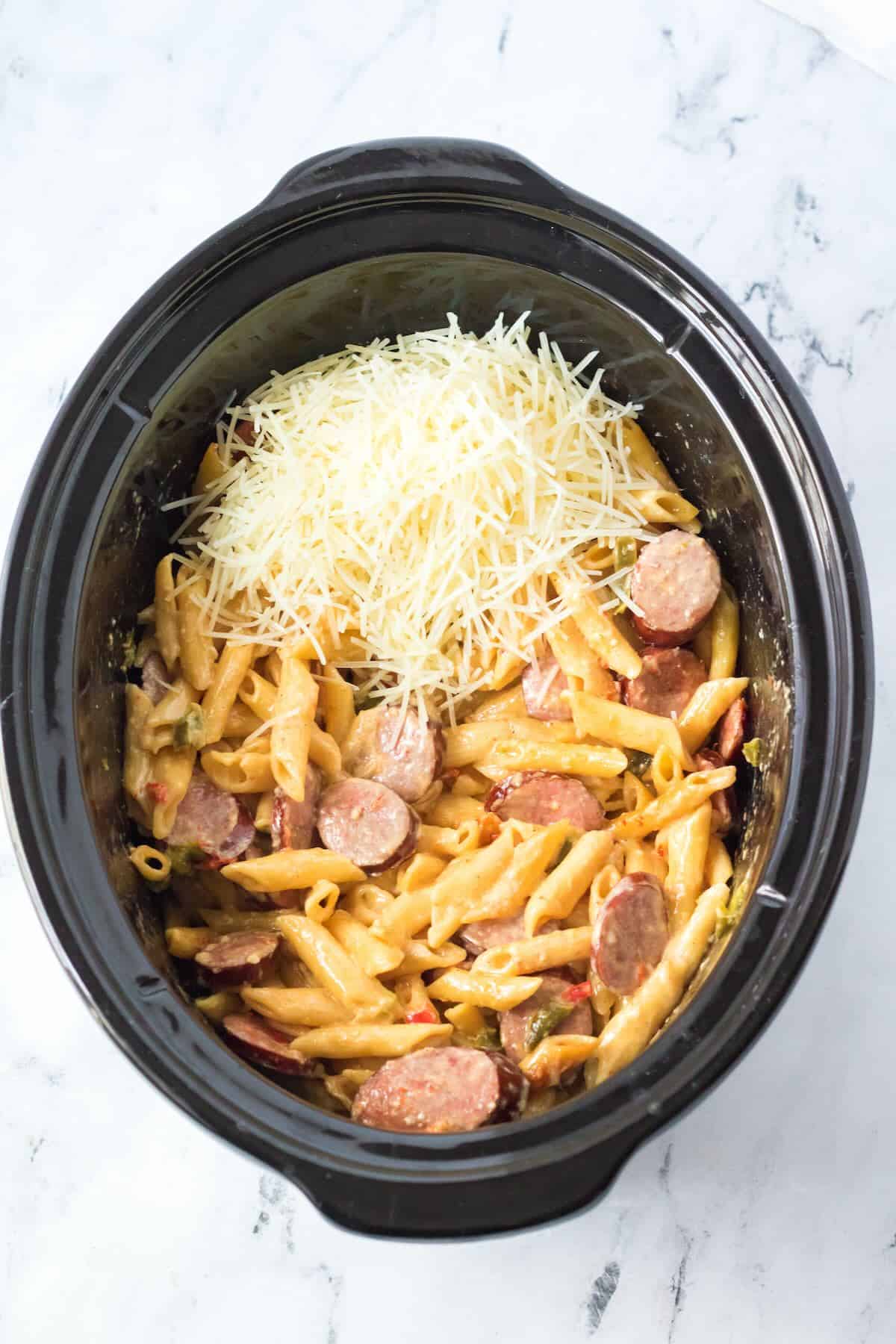 Parmesan cheese and shredded chicken added back to the crockpot.