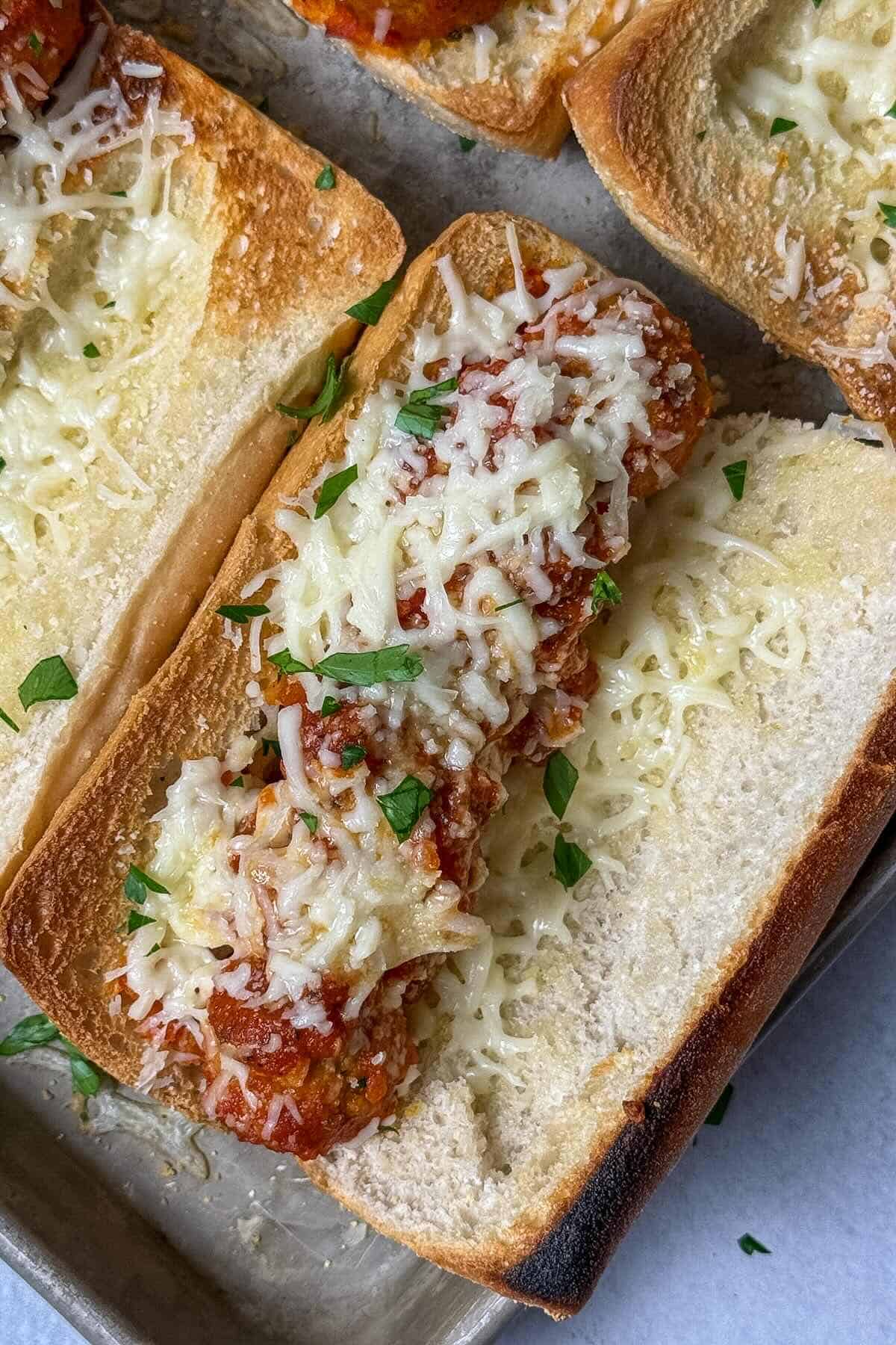 Meatball subs baked in the oven until the cheese is melted and bubbly.
