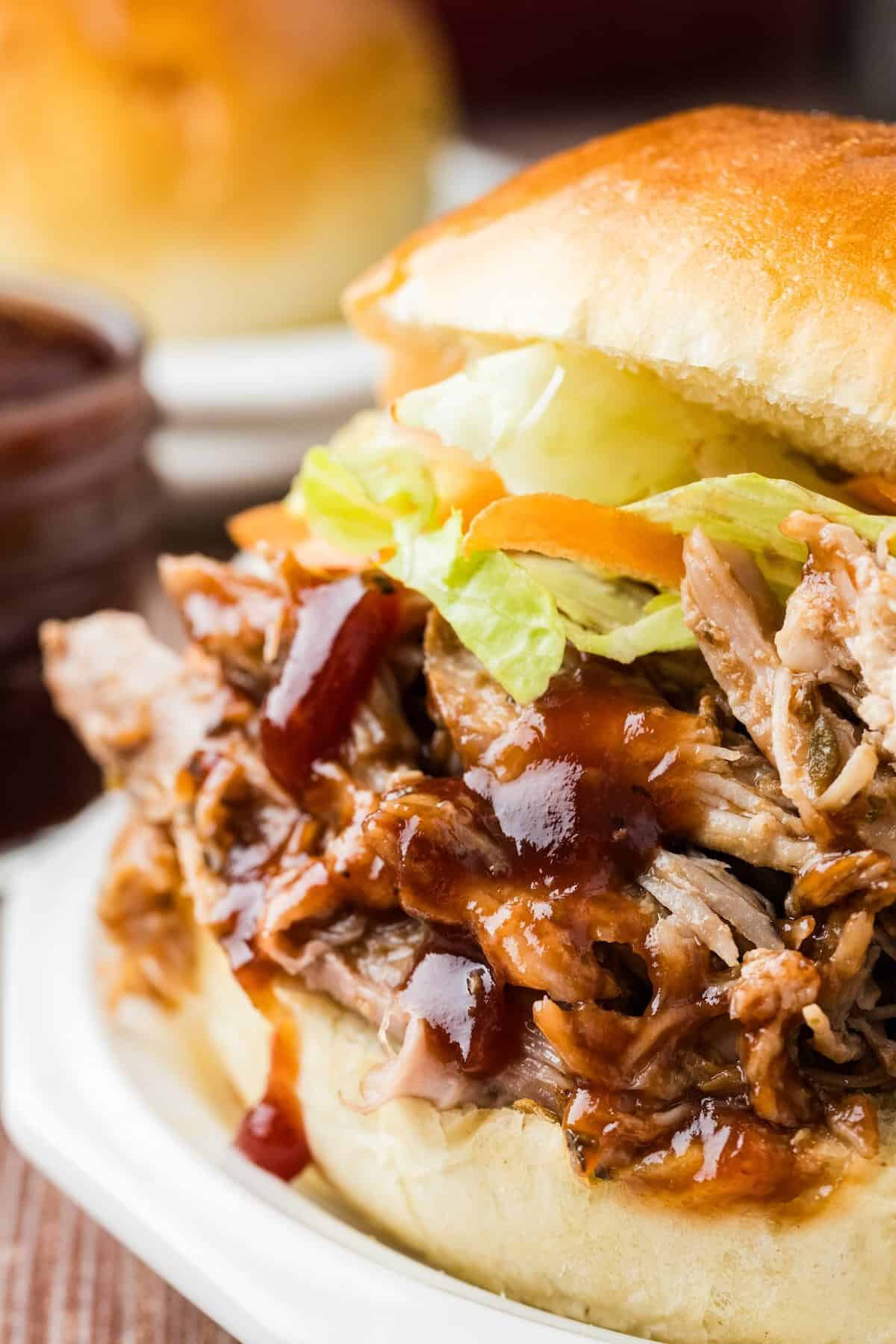 A saucy bbq pulled pork sandwich on a toasty bun.