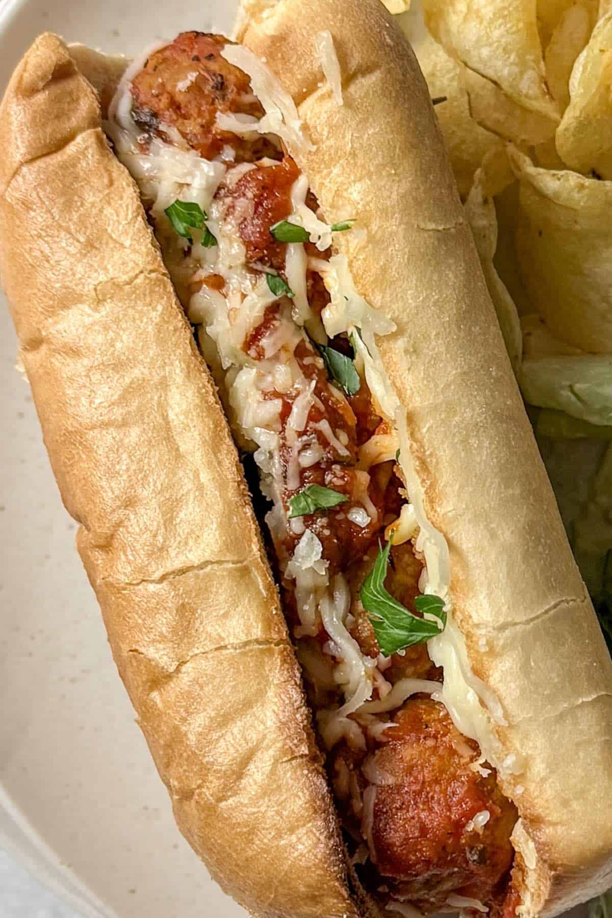 Close-up of a meatball sub made with frozen meatballs, marinara sauce and melted mozzarella cheese.