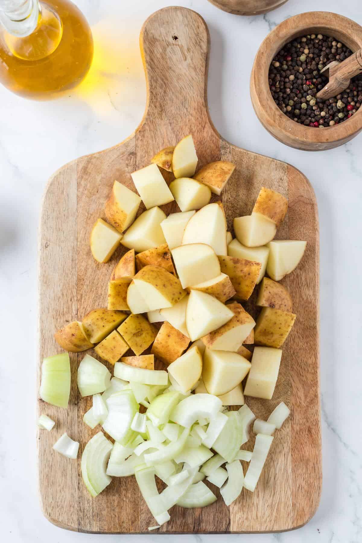 Cutting russet potatoes into cubes for air fryer breakfast potatoes.
