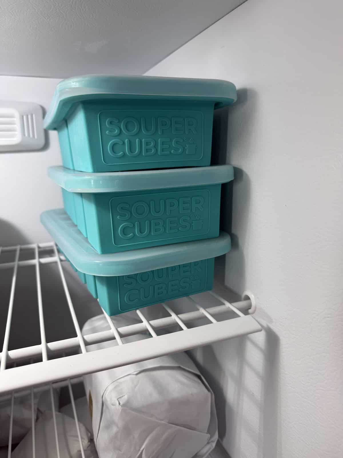 Soup frozen in Souper Cubes silicone freezer trays stacked in freezer.