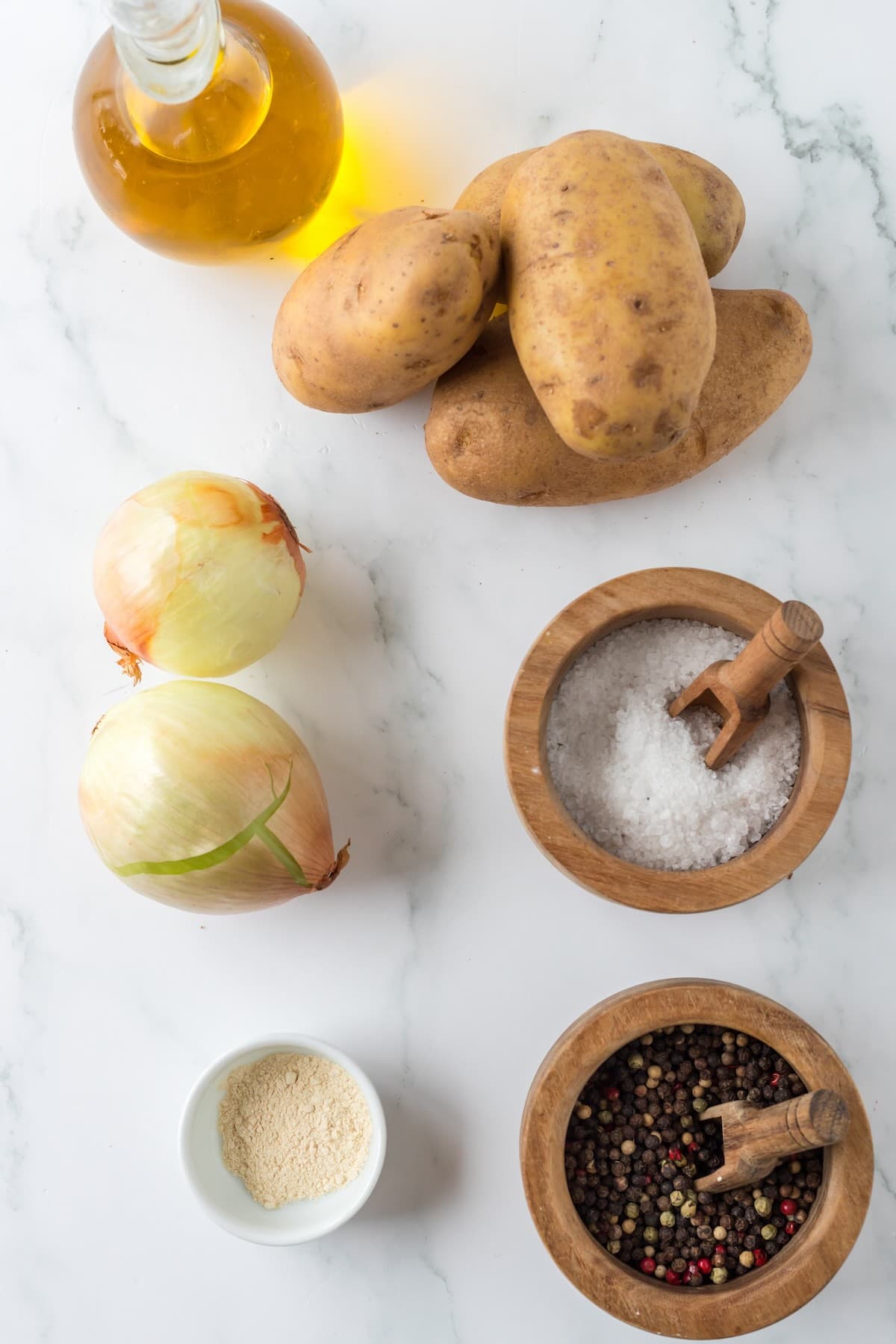 Ingredients for air fryer breakfast potatoes including russet potatoes onions and seasonings.