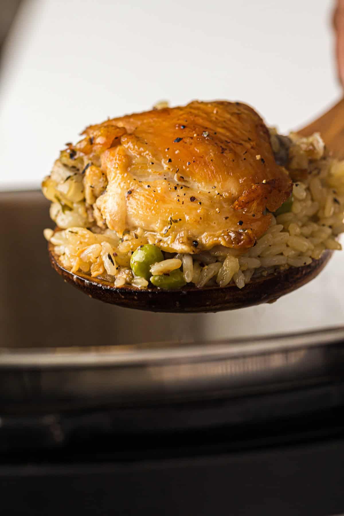Close-up of Instant Pot chicken and rice with tender chicken thighs and fluffy rice. 