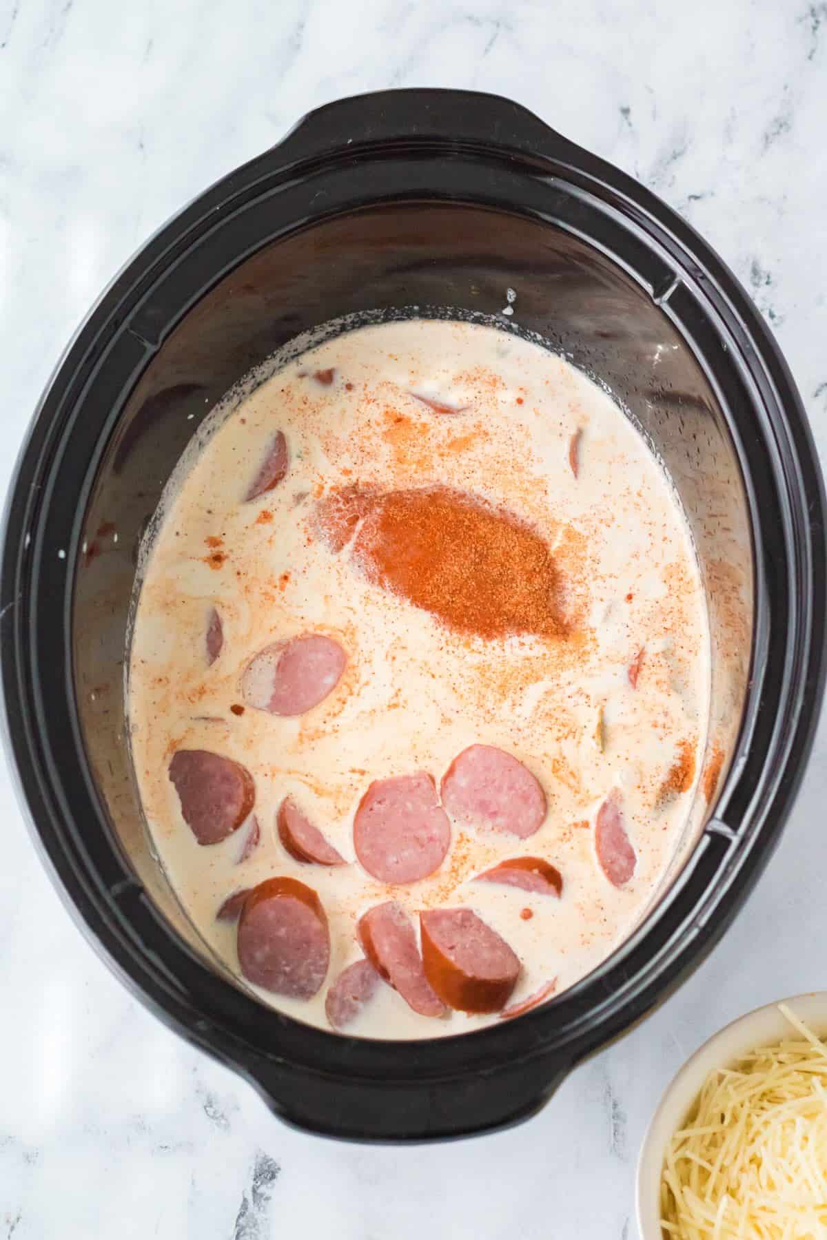Kielbasa and chicken in a cream sauce in the slow cooker.
