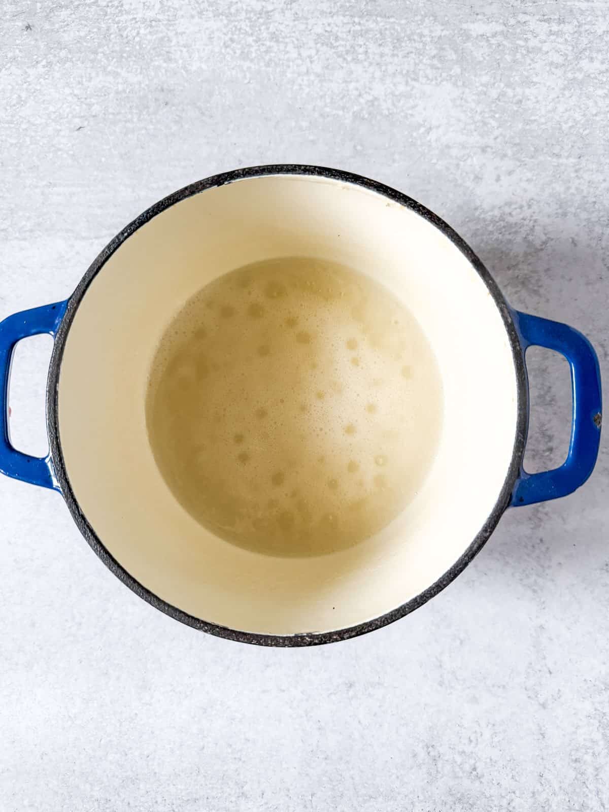 Pectin and water coming to a boil in a saucepan.