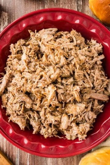 Slow cooker pulled pork in a dish.