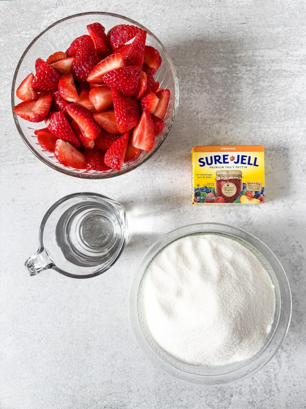 Hulled strawberries, sugar, pectin and water to make a freezer jam.