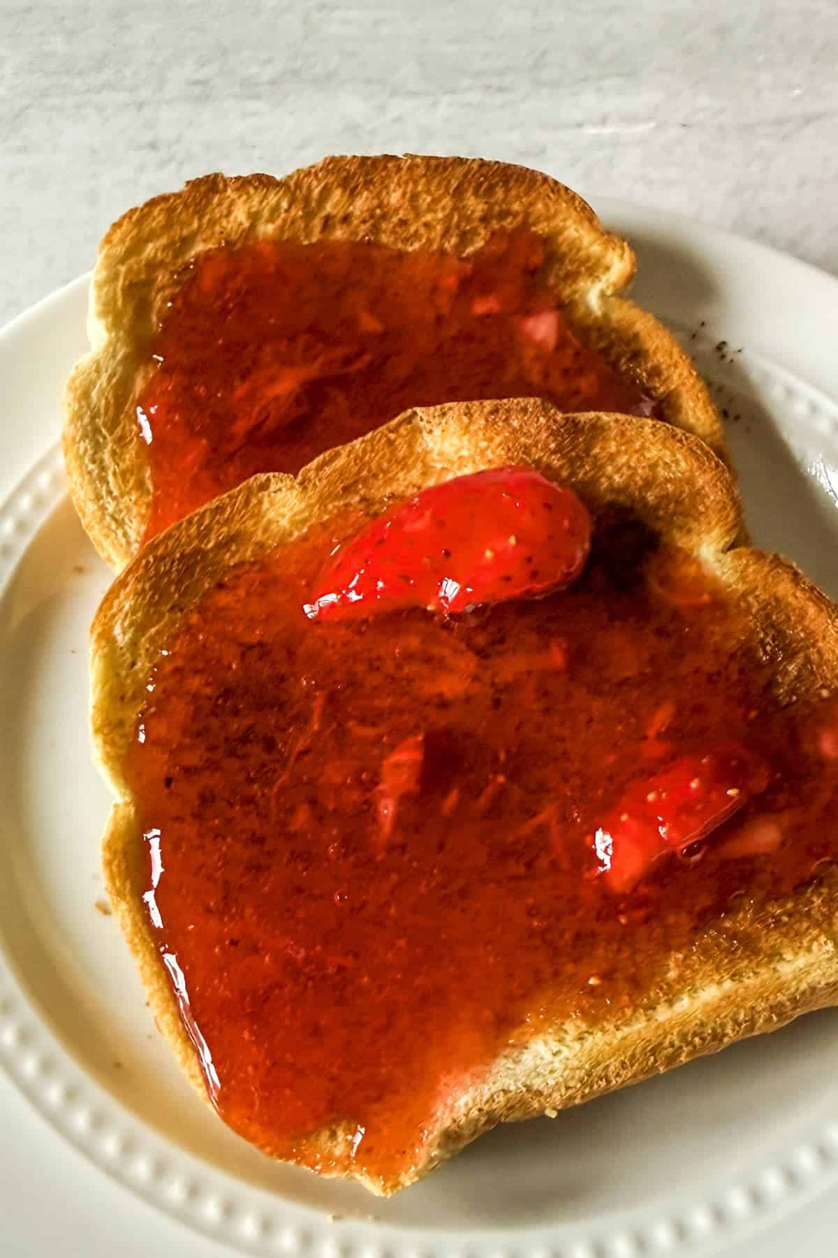 Strawberry freezer jam spread on toast.