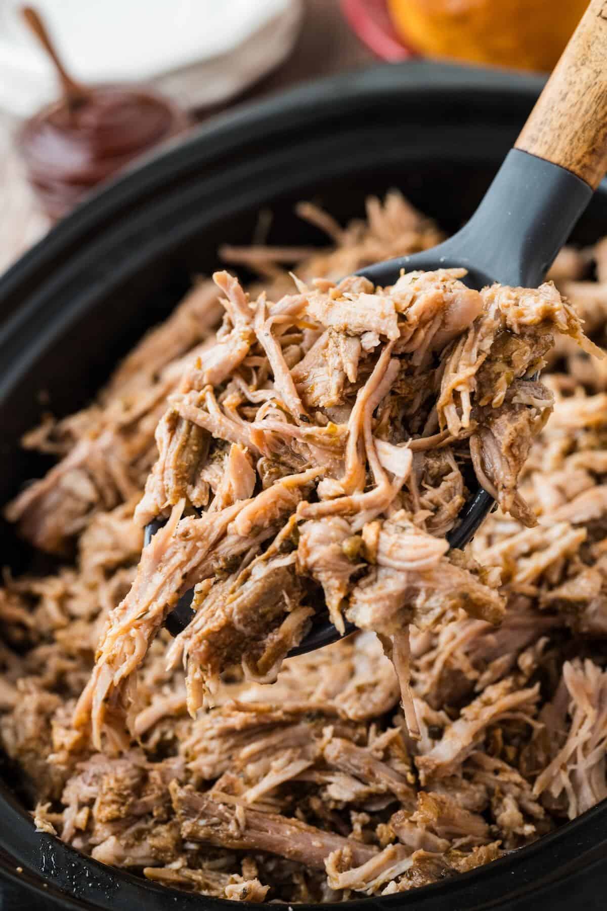 A spoonful of shredded pork shoulder, ready to serve on sandwiches or used for leftovers.