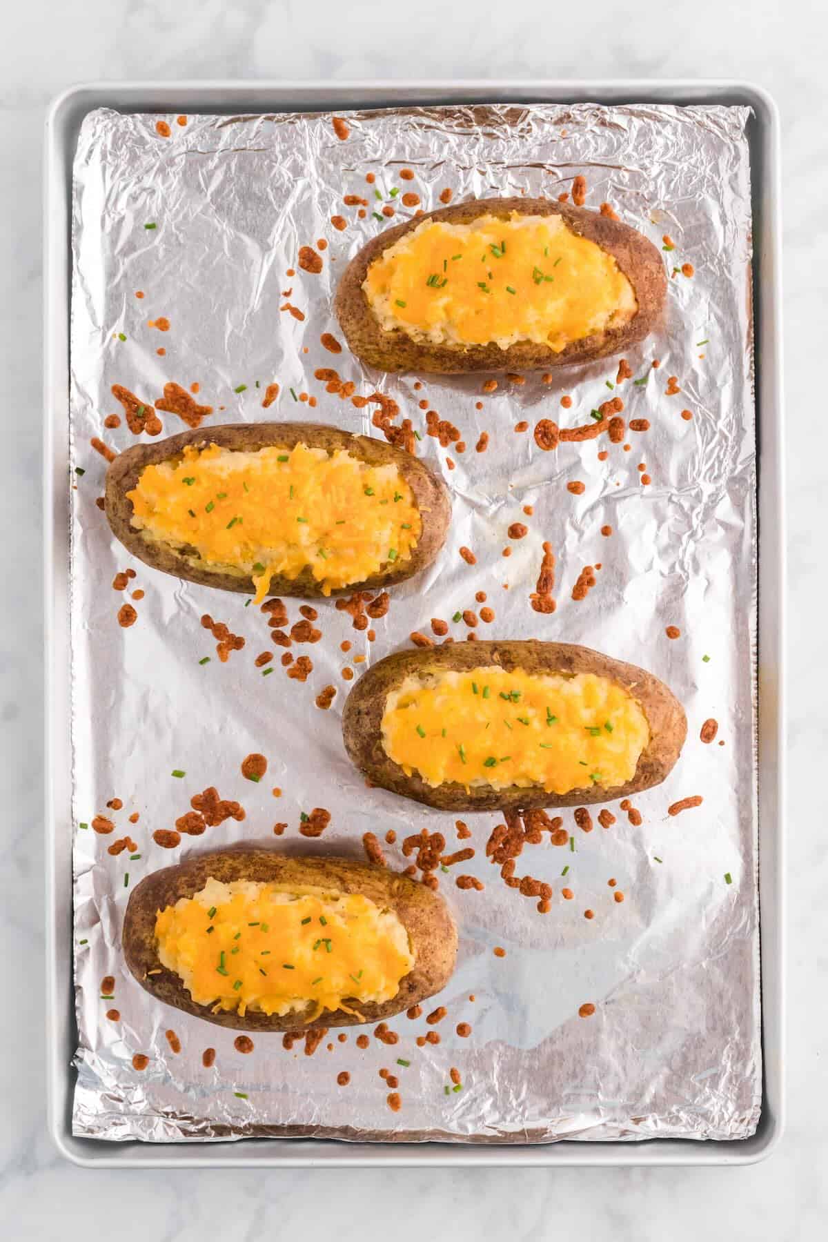 Golden twice baked potatoes topped with melted cheese.