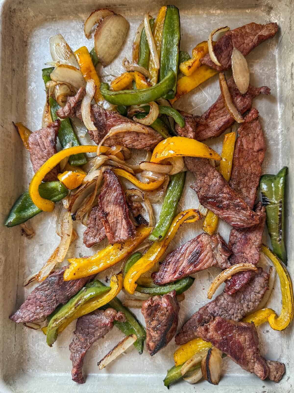 Oven baked beef fajitas, ready to be plated and served.