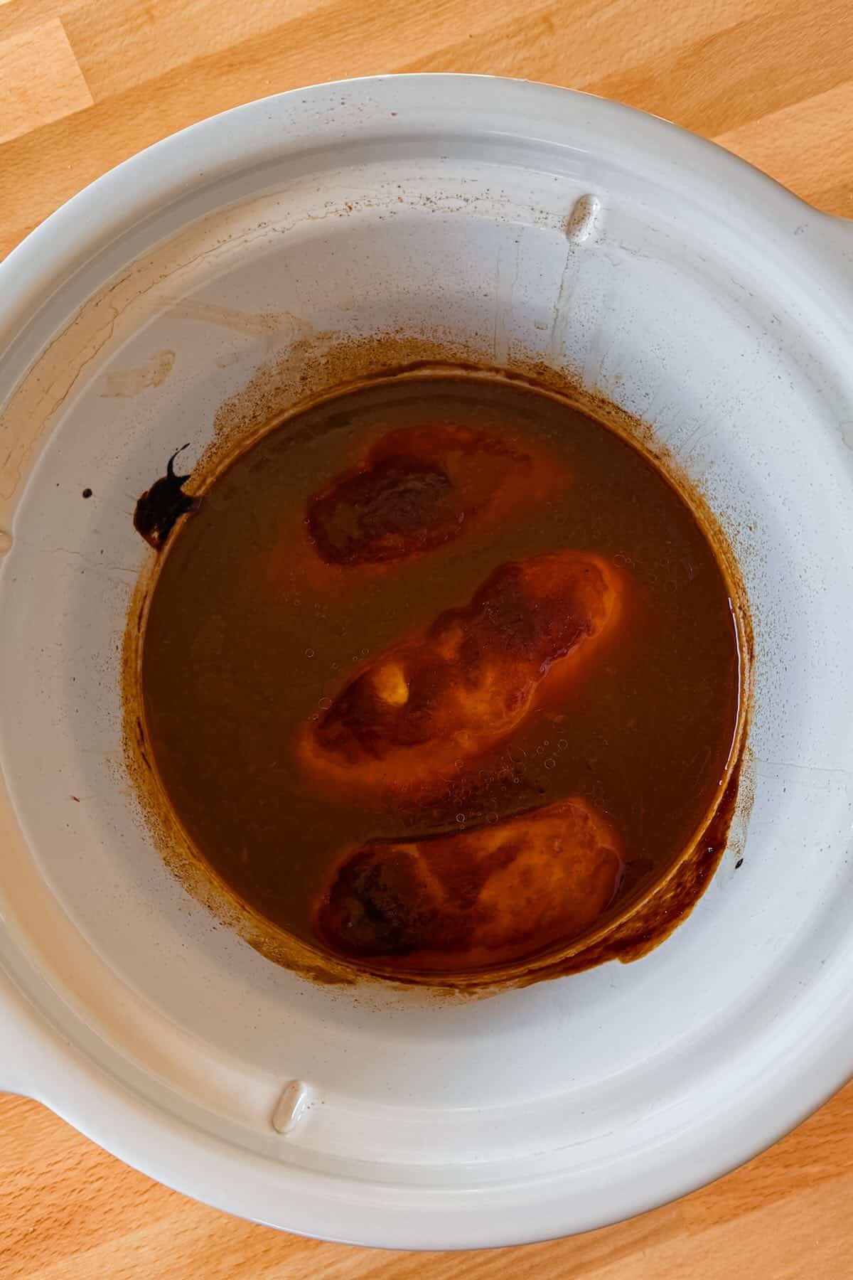 Cooke bbq chicken in the crockpot before shredding.