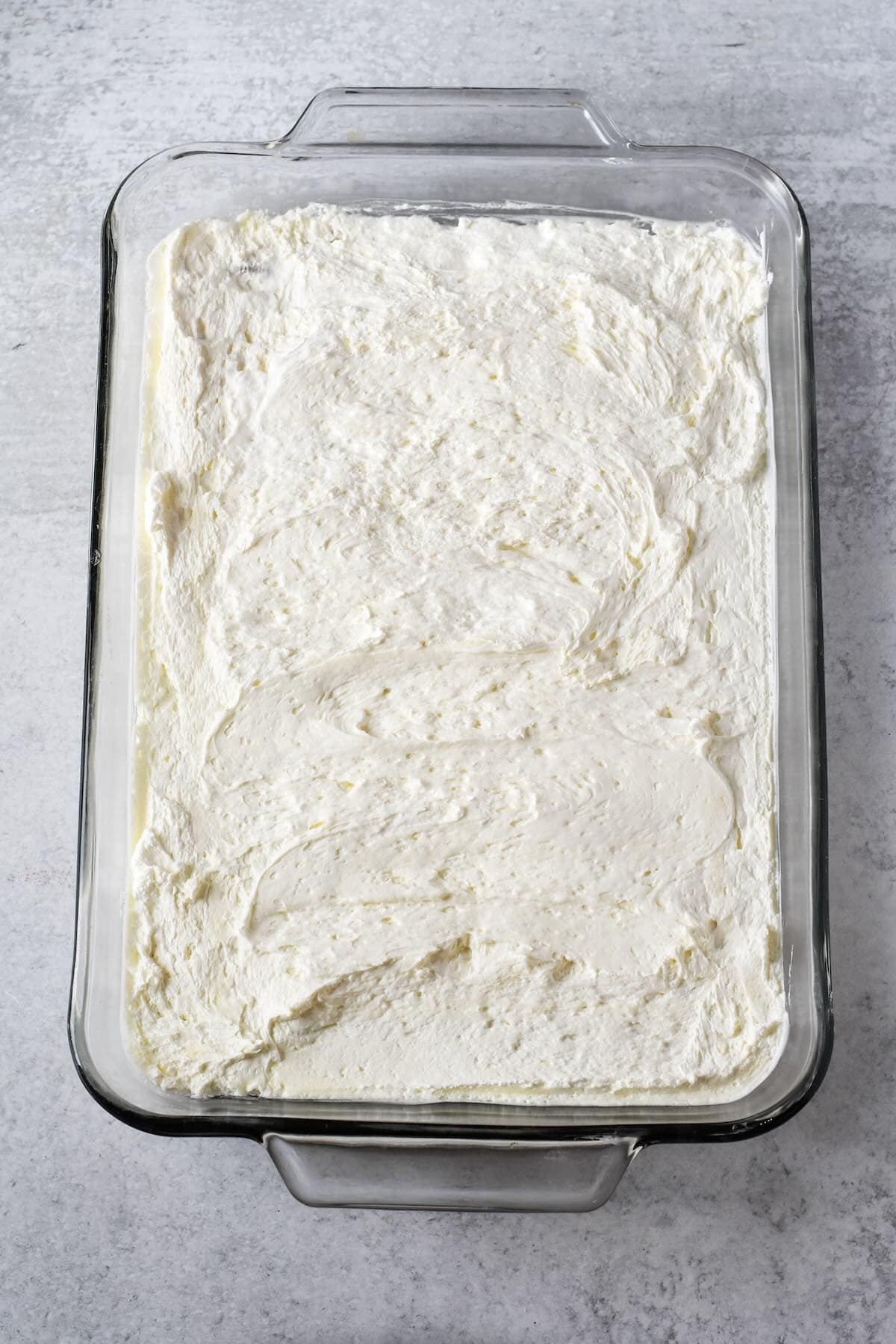 Cream cheese and whipped topping layer spread over pretzel crust to prevent soggy layers.