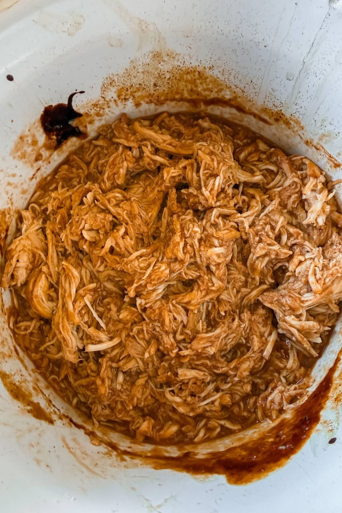 Shredded chicken with bbq sauce in the slow cooker.
