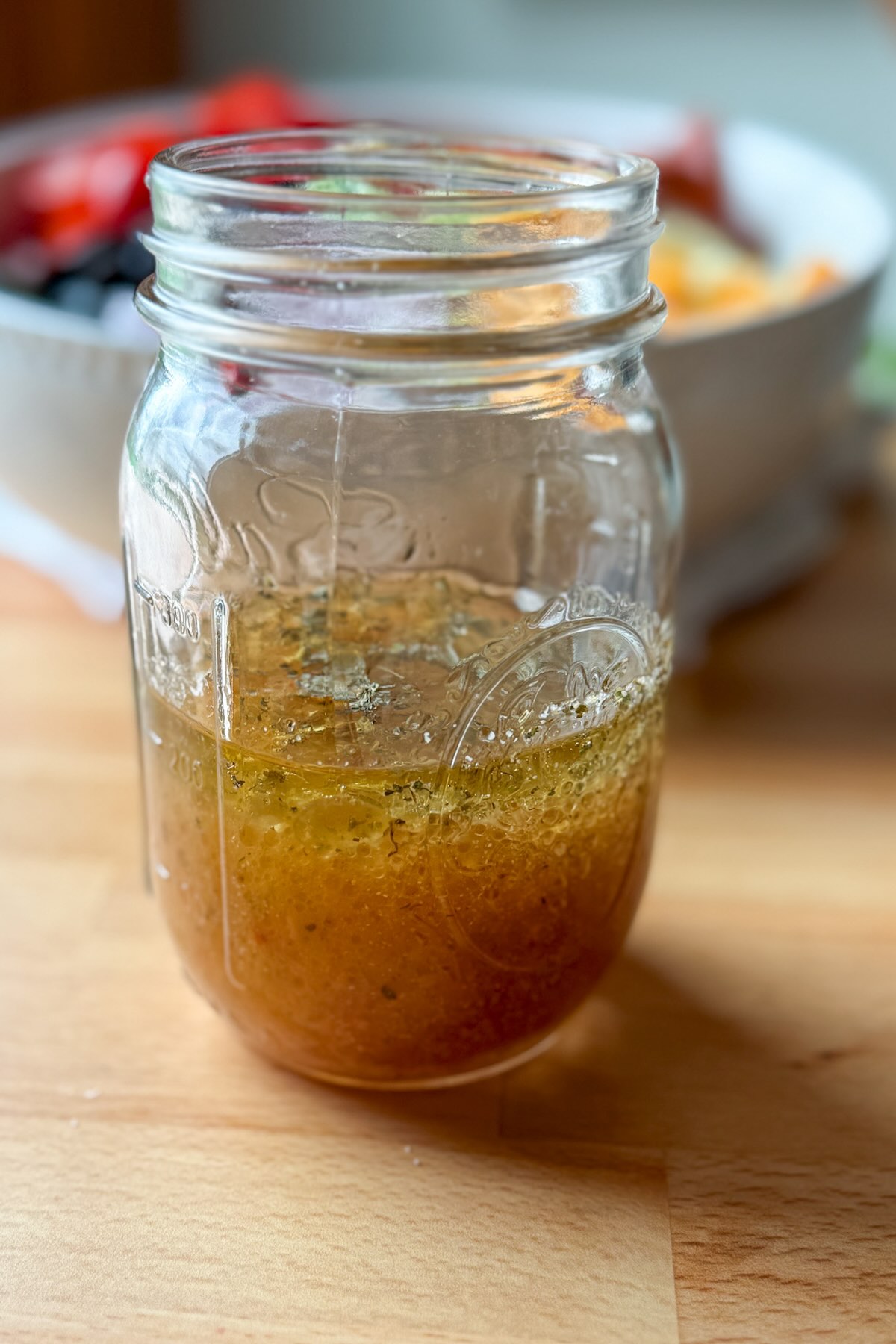 Italian dressing with vinegar, sugar, and seasonings mixed for pasta salad.