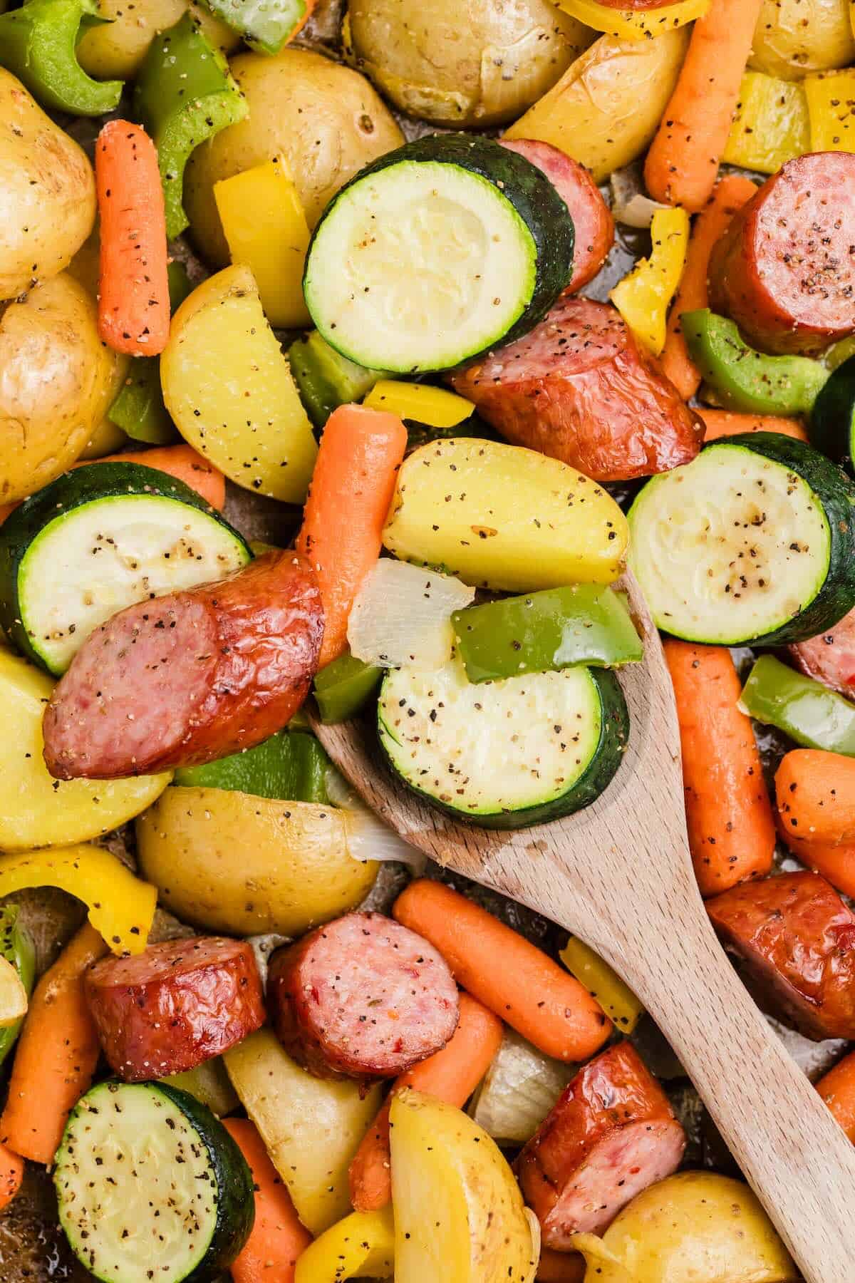 Close up of kielbasa sheet pan dinner with roasted vegetables and potatoes.