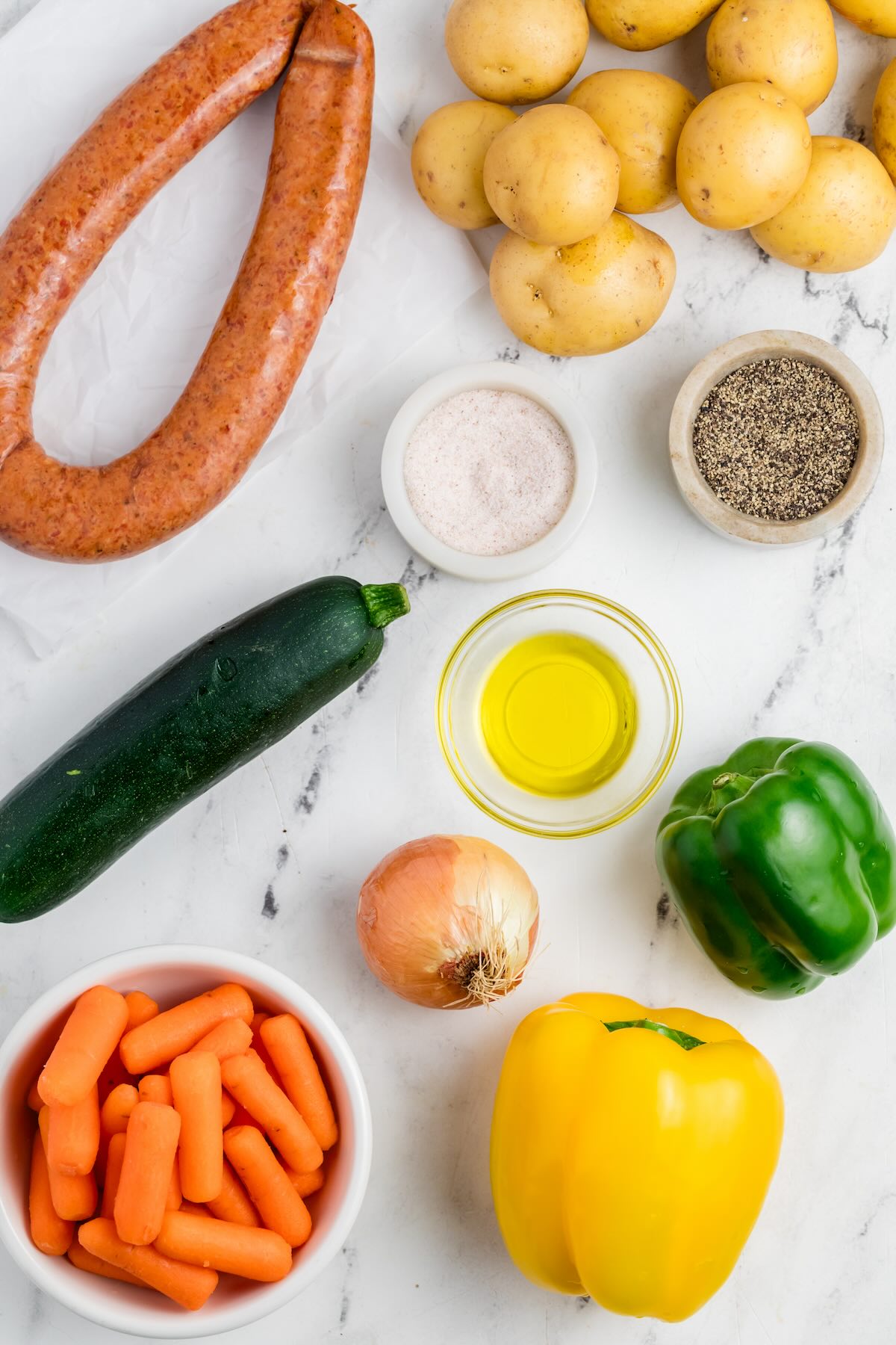 Vegetables and kielbasa on a counter to make an easy weeknight dinner.