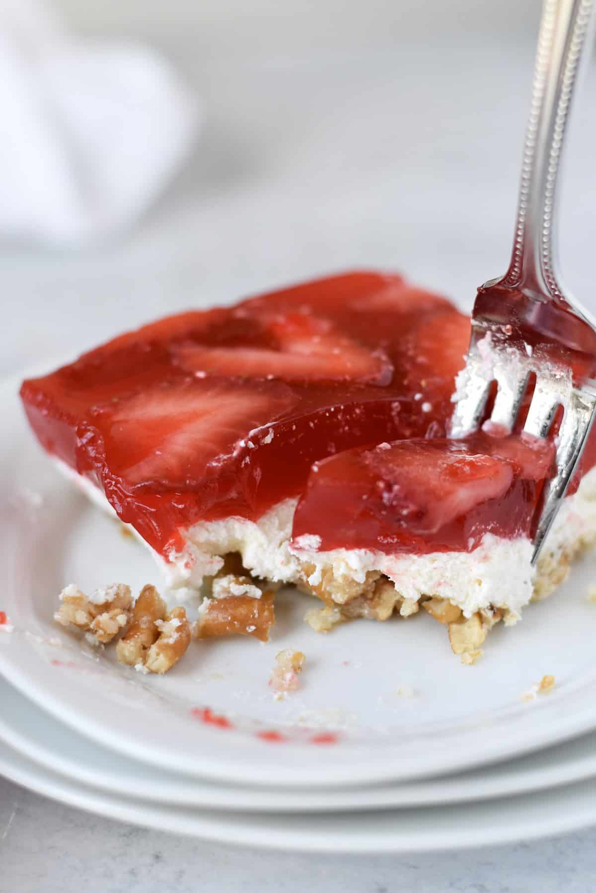 Close up of strawberry pretzel salad showing creamy and crunchy layers.
