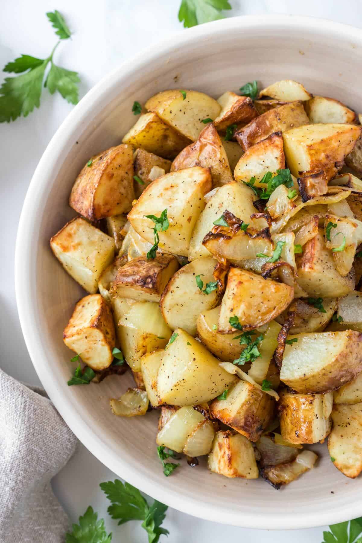 Air fryer breakfast potatoes in a bowl on the counter, ready to serve.