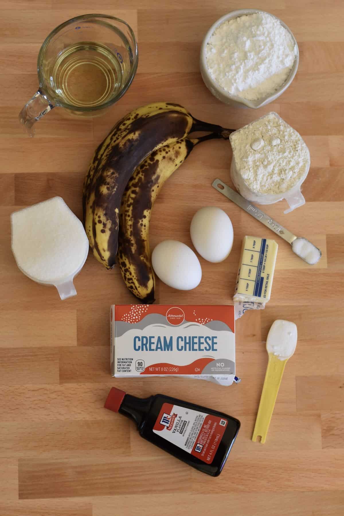 Ingredients for banana bars including ripe bananas, flour, eggs, and cream cheese.