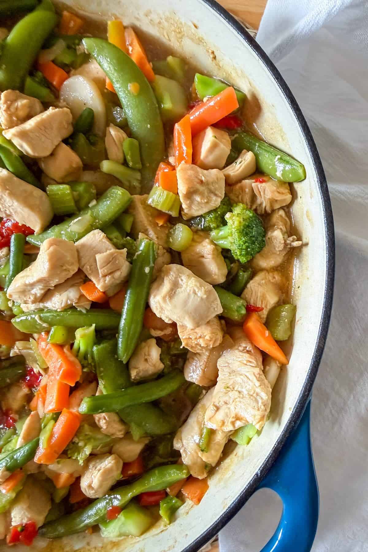 Prepared chicken stir fry in a skillet ready to serve.