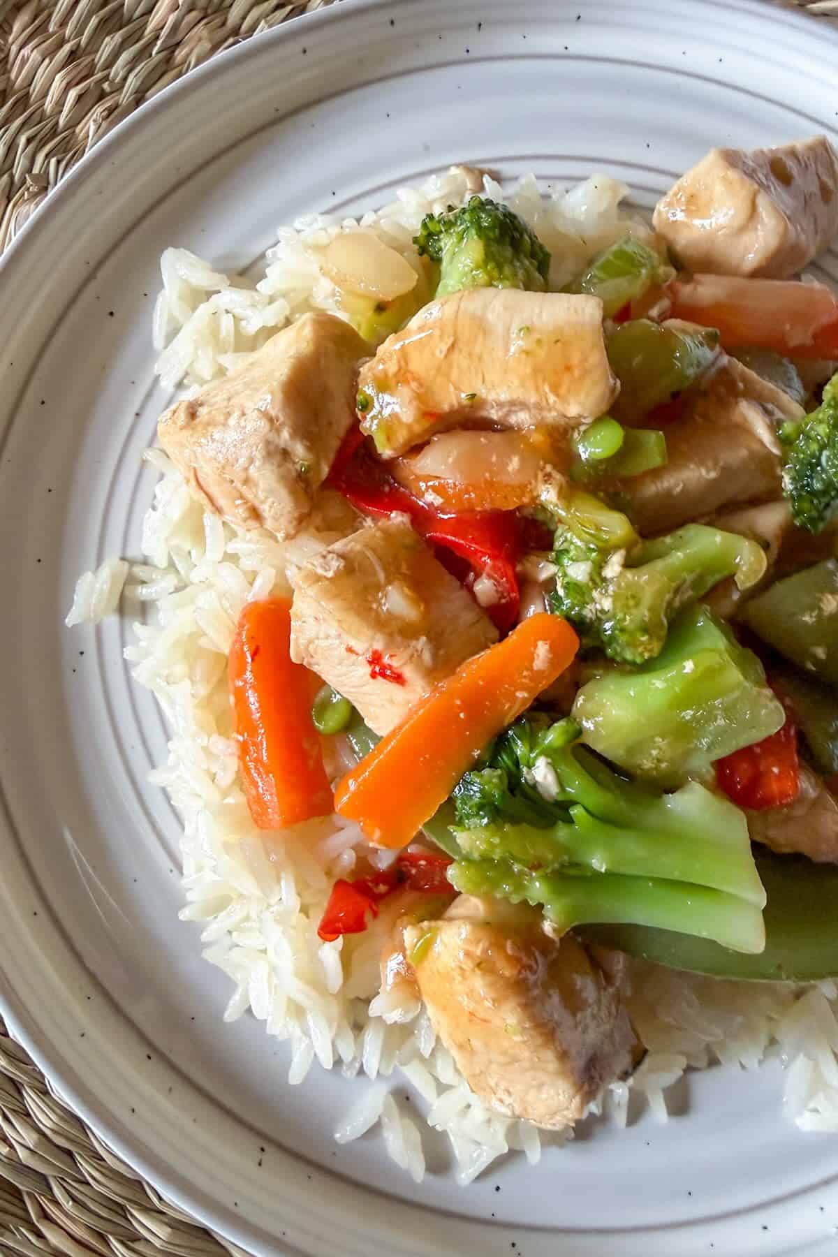 Easy chicken stir fry recipe with frozen vegetables and homemade sauce.