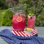A pitcher of blueberry lemonade with mint.
