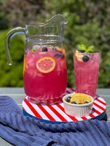 A pitcher of blueberry lemonade with mint.
