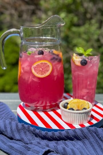A pitcher of blueberry lemonade with mint.